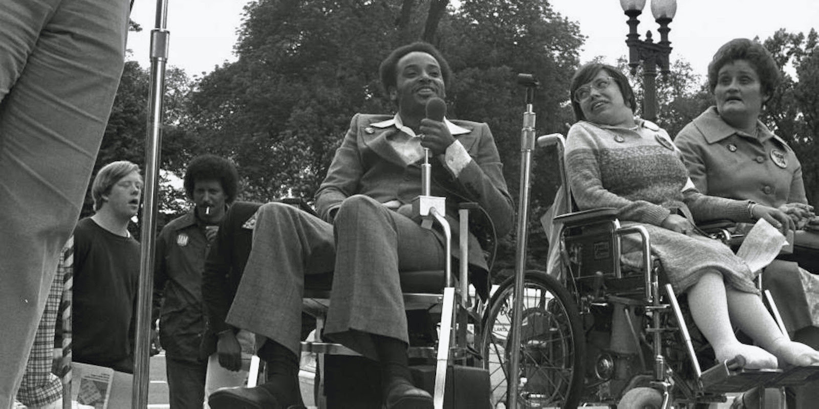 A black-and-white photograph of disabled activists with Brad Lomax and Judith Heumman front and center.